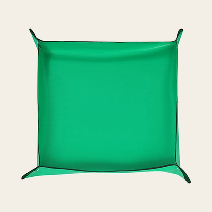 The same mat with its four corners snapped up into a shallow tray, about 50 x 50 cm