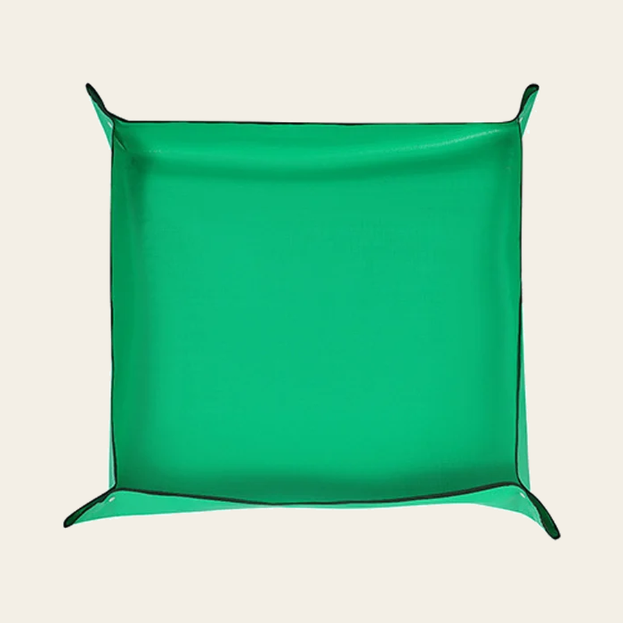 The same mat with its four corners snapped up into a shallow tray, about 50 x 50 cm