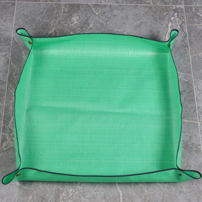 Empty green repotting mat with corners snapped up